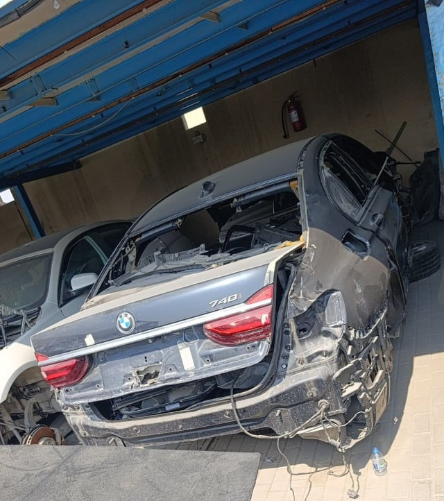 Dark grey BMW 7-Series 740 rear halfcut with trunk lid, taillights and quarter panels at a Sharjah market shop