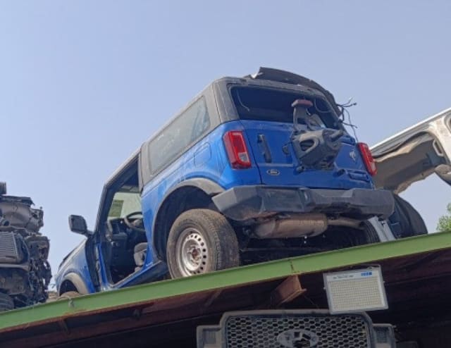 Blue Ford Bronco 2-door car for parts, rear view with tailgate, taillights and bumper, Sharjah market