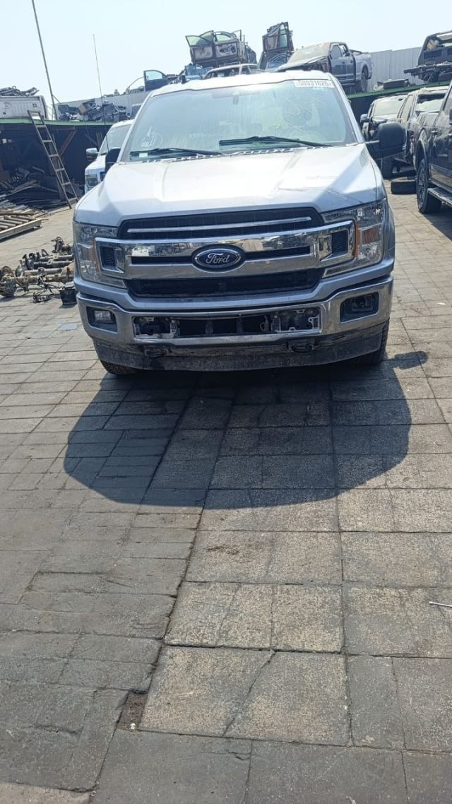 Silver Ford F150 pickup front view — chrome grille, headlights, hood and bumper, Sharjah market