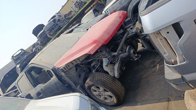 Dark grey Ford F-250 Super Duty halfcut with red hood, exposed front suspension and wheel, Sharjah market