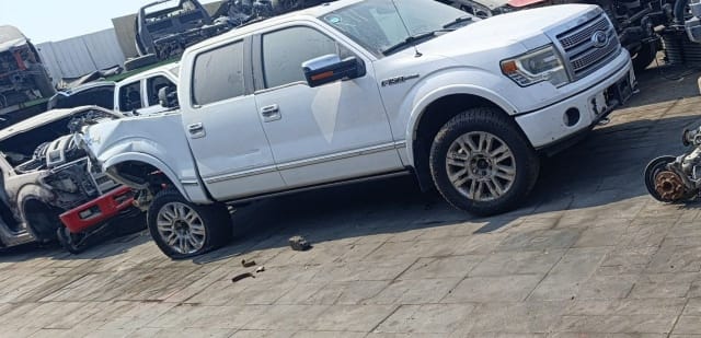 White Ford F150 crew cab pickup for parts — grille, headlights, doors and alloy wheels, Sharjah market