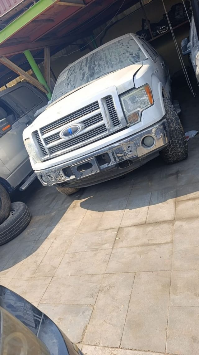 White Ford F150 pickup for parts: chrome bumper, grille and headlights, Sharjah market