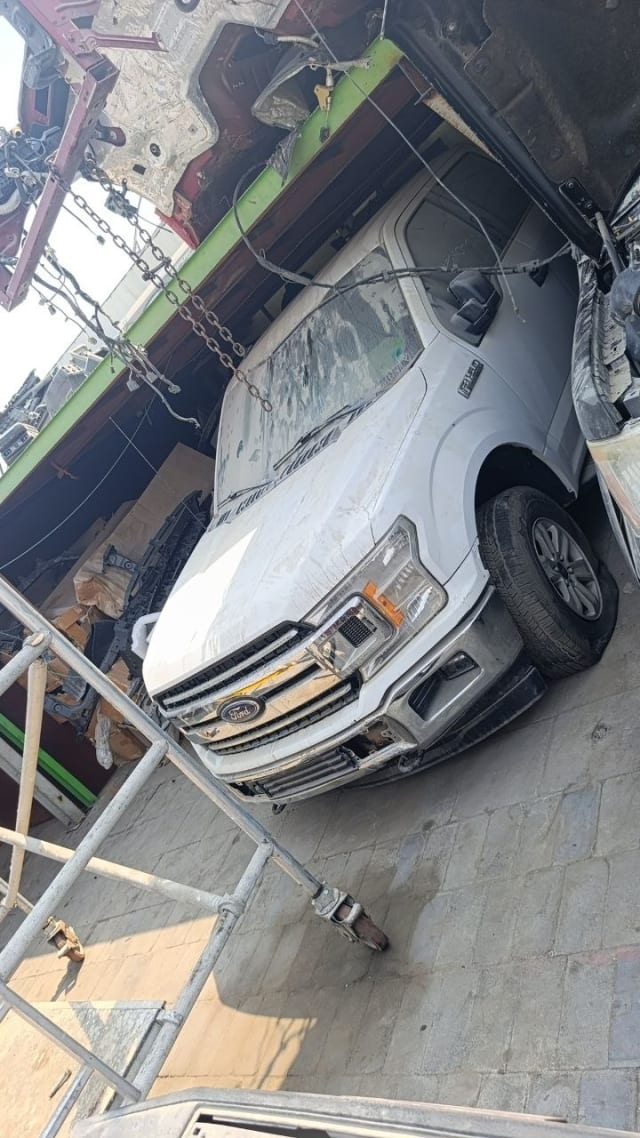 White Ford F150 pickup for parts: chrome grille, headlights, hood and front bumper, Sharjah market