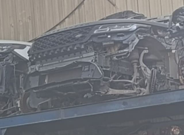 Land Rover Range Rover Evoque front halfcut on a rack: grille, radiator and front suspension, Sharjah market