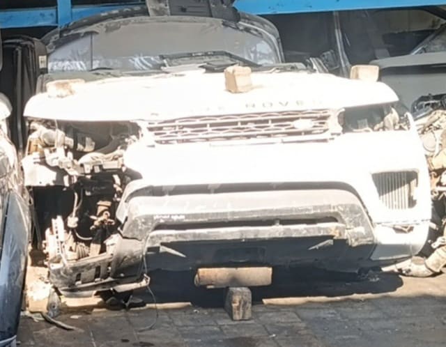 White Land Rover Range Rover Sport halfcut — hood, grille and front bumper, Sharjah market