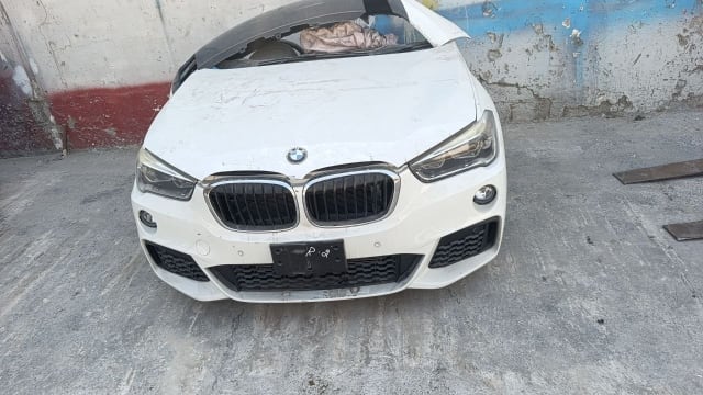 White BMW X1 front halfcut — hood, kidney grille, headlights and front bumper, Sharjah market