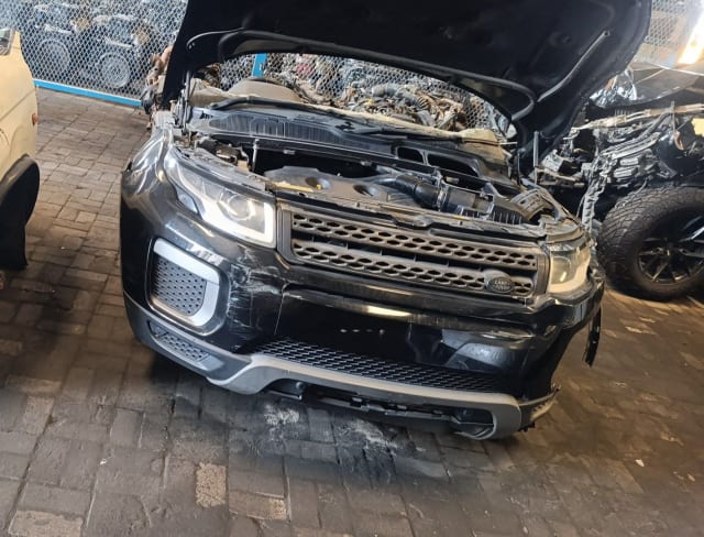 Black Range Rover Evoque front halfcut, hood open: bumper, grille, headlights and engine bay, Sharjah market