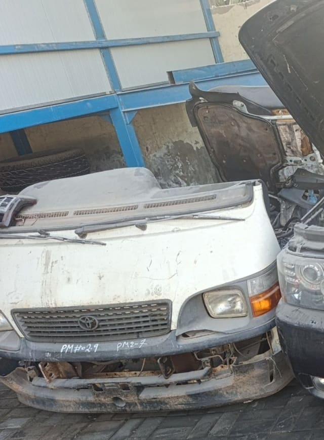 White Toyota Hiace van front cut with grille, headlight, bumper and dashboard, Sharjah market