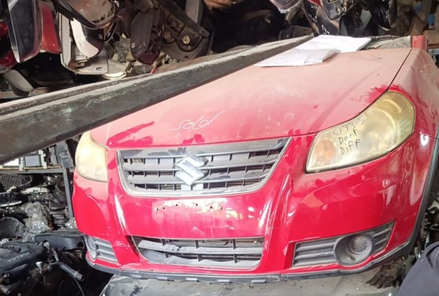 Red Suzuki SX4 front halfcut — hood, grille, headlights and front bumper, Sharjah market