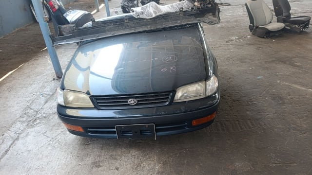 Dark green Toyota Corona front halfcut with hood, grille, headlights and bumper on the Sharjah market