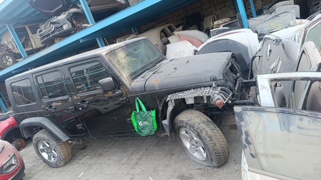 Black Jeep Wrangler Unlimited car for parts — doors, hood, hardtop, front end stripped, Sharjah market