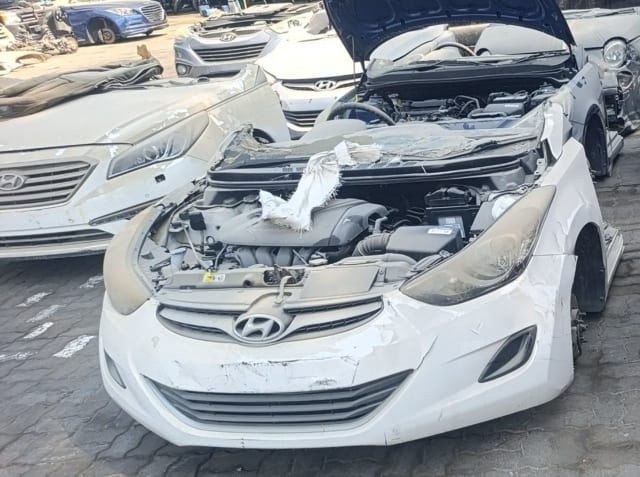 White Hyundai Elantra sedan front halfcut with engine, bumper, grille and headlights, Sharjah market