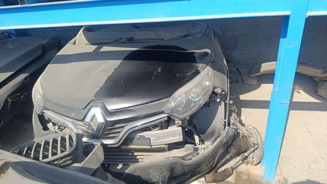 Dark grey Renault Captur front halfcut: hood, chrome grille, headlight and damaged bumper, Sharjah market