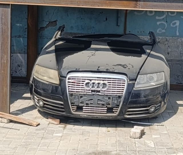 Black Audi A6 front halfcut: hood, chrome grille, headlights and bumper, Sharjah market