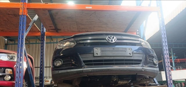 Dark blue Volkswagen Tiguan front halfcut — bumper, chrome grille, headlights and fog lights, Sharjah market