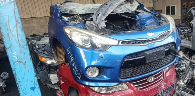Blue Kia Cerato front halfcut with bumper, grille and headlights, damaged hood, Sharjah market