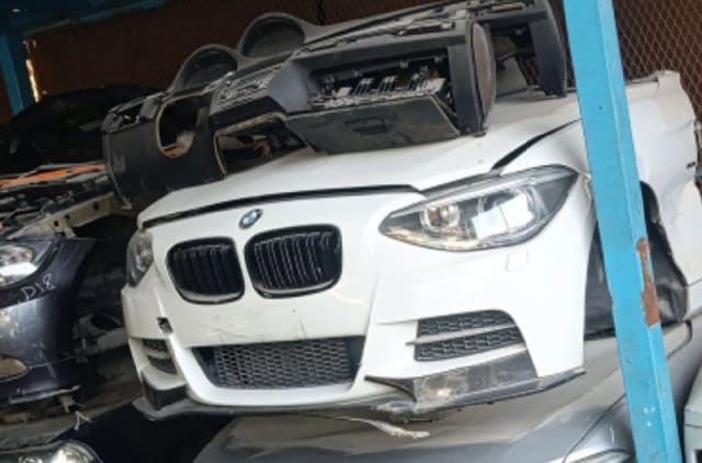 White BMW 1-Series front halfcut with hood, black grille, headlights and bumper, Sharjah market