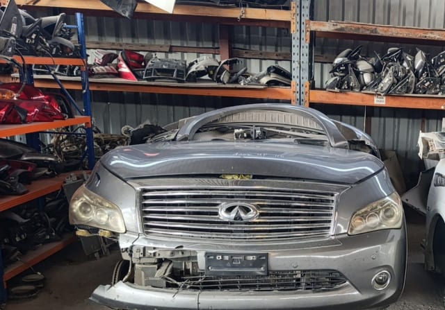Grey Infiniti QX56 / QX80 front halfcut — chrome grille, headlights, hood and bumper, Sharjah market
