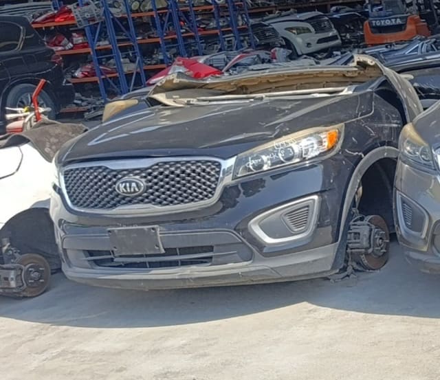 Black Kia Sorento front halfcut — grille, bumper, headlight, hood and brake discs, Sharjah market