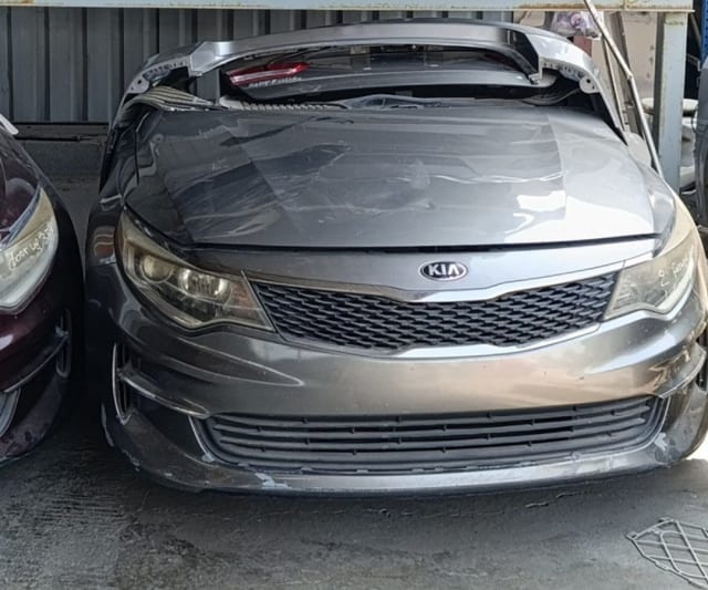 Grey Kia Optima front halfcut with hood, bumper, grille and headlights, trunk lid on top, Sharjah market