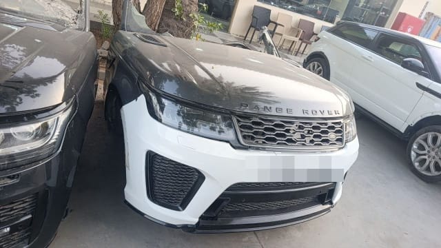 White and grey Land Rover Range Rover Sport front cut — bumper, grille and headlights, Sharjah market