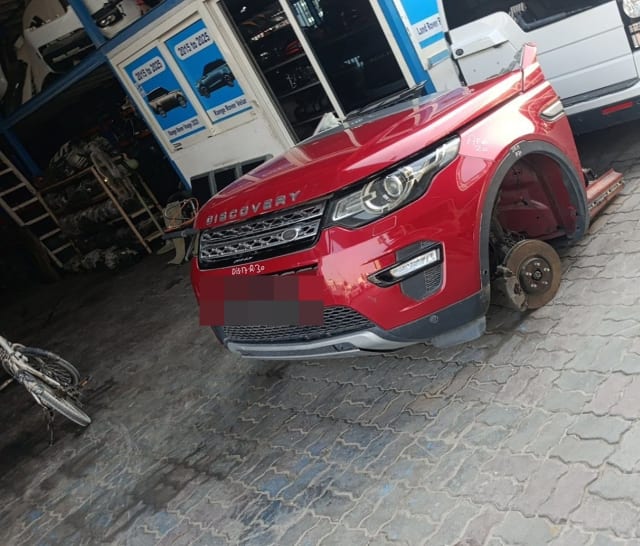 Red Land Rover Discovery Sport front halfcut with hood, bumper, grille and headlight, Sharjah market