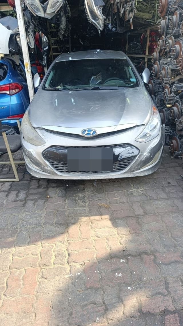 Silver Hyundai Sonata sedan car for parts, front view with bumper, grille, hood and headlights, Sharjah market