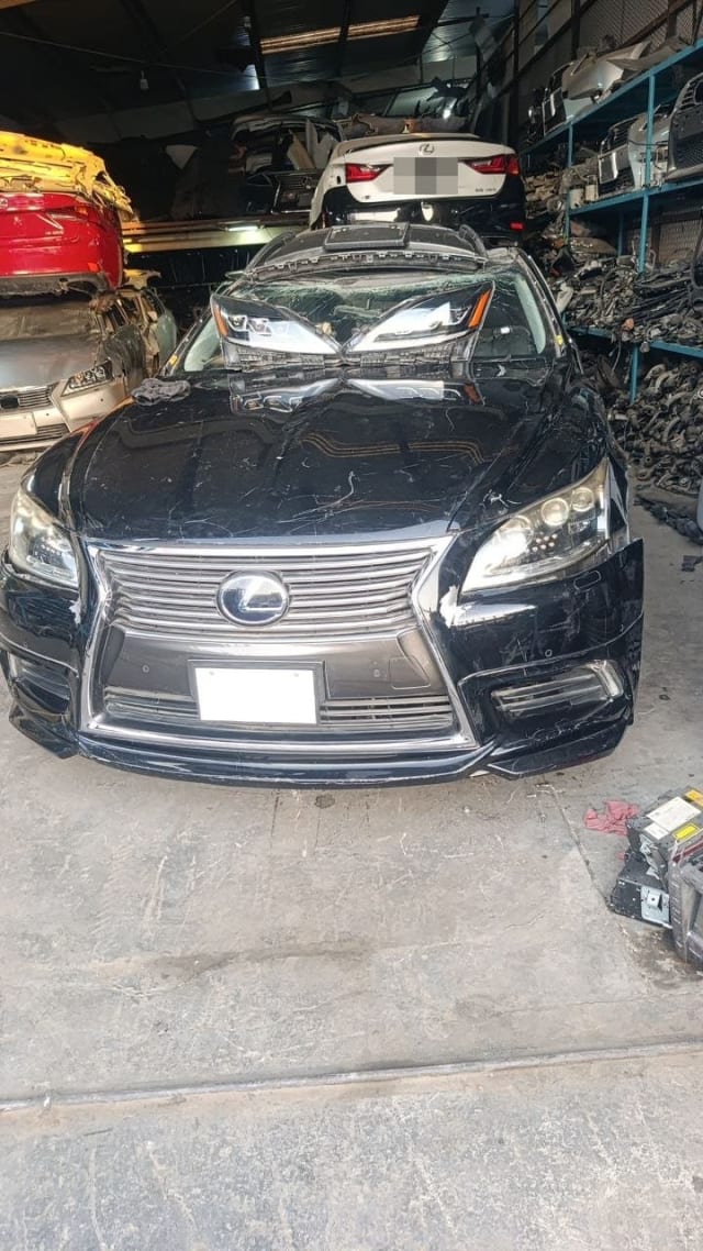 Black Lexus LS460 car for parts, front view with spindle grille, bumper and headlights, Sharjah market