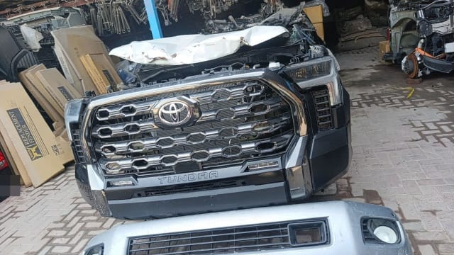 Toyota Tundra front halfcut — chrome grille, TUNDRA bumper, headlight and crumpled hood, Sharjah market