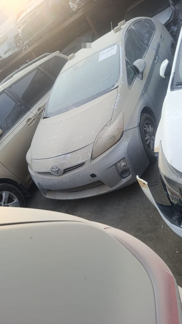 Dusty silver Toyota Prius hatchback for parts: front bumper, headlights, hood and grille, Sharjah market
