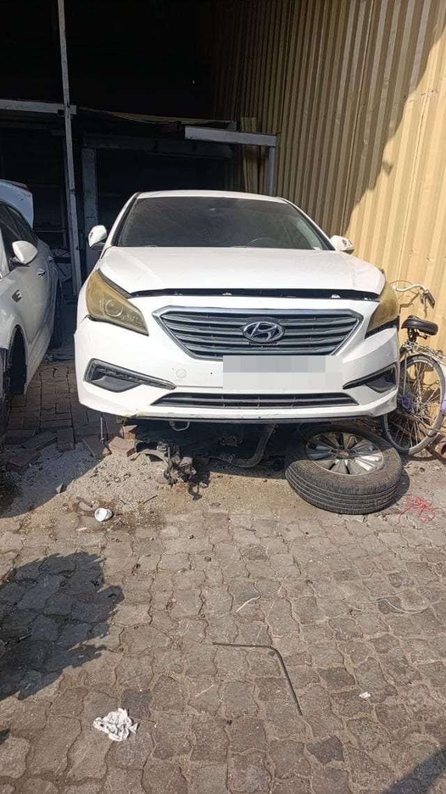 White Hyundai Sonata car for parts, front view with bumper, grille and headlights, Sharjah market