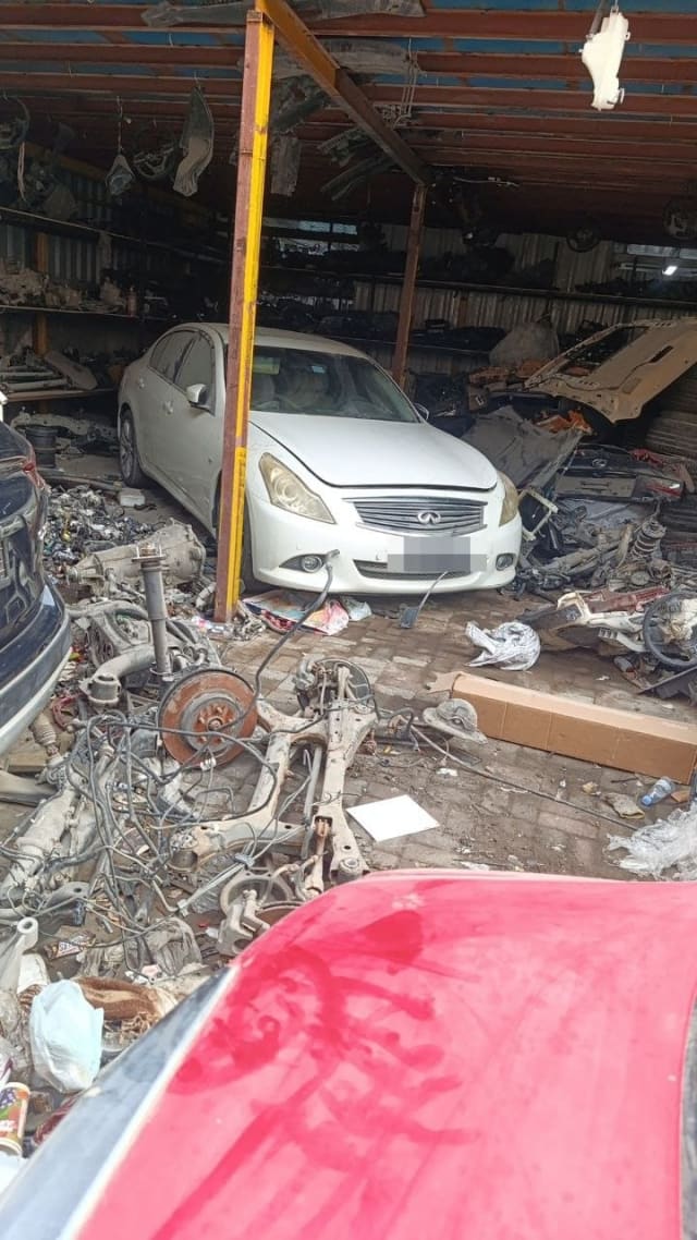 White Infiniti G25/G37 sedan for parts with bumper, grille and headlights, beside a subframe, Sharjah market