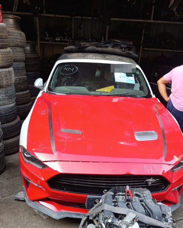 Red Ford Mustang halfcut, hood with vents, bumper, grille, headlights, engine in front, Sharjah market