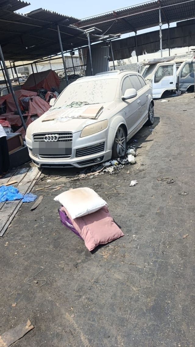 Dusty silver Audi Q7 SUV car for parts — front bumper, grille, headlights and alloy wheels, Sharjah market