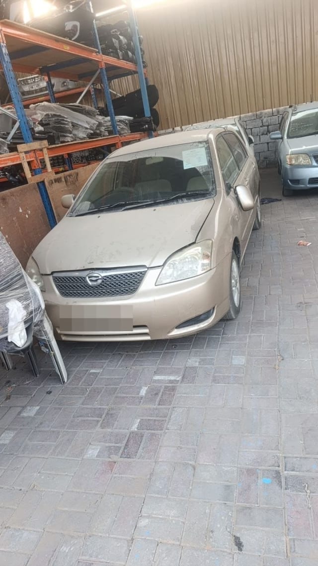 Gold Toyota Corolla sedan car for parts — front bumper, grille, headlights and hood, Sharjah market