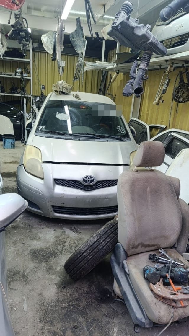 Silver Toyota Yaris hatchback for parts, front view with bumper, grille and headlights, Sharjah market