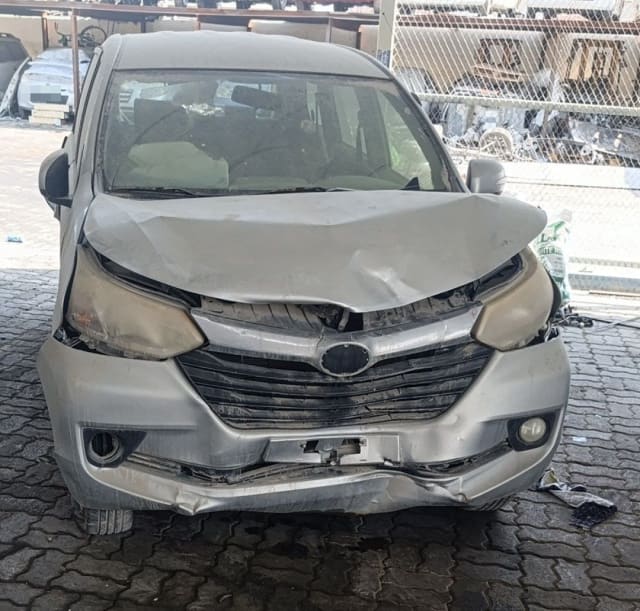Silver Toyota Avanza MPV for parts, front view with damaged hood and bumper, headlights and grille, Sharjah market