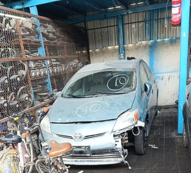 Light blue Toyota Prius hatchback for parts — hood, headlights, grille and damaged front bumper, Sharjah market