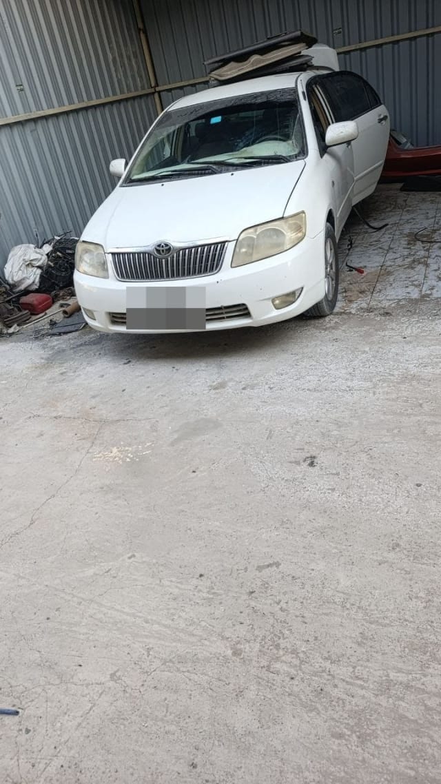 White Toyota Corolla sedan for parts — front bumper, grille, headlights and hood, Sharjah market