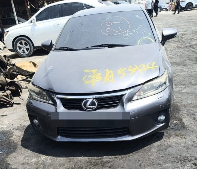 Grey Lexus CT200h hatchback for parts, front view with bumper, grille, headlights and hood, Sharjah market