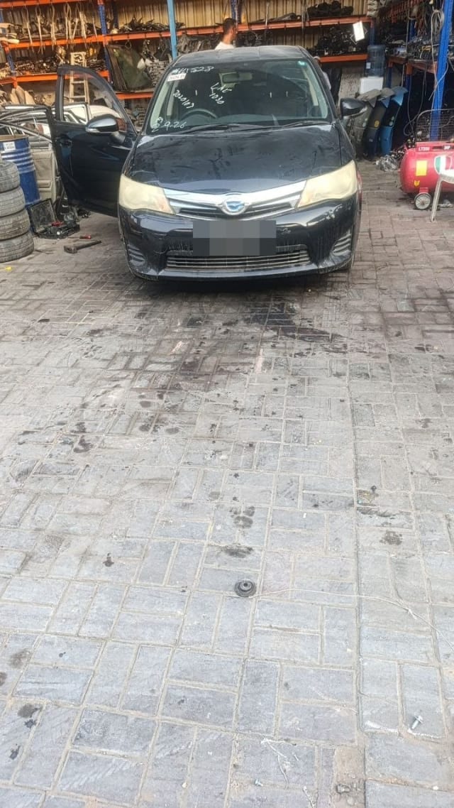 Black Toyota Corolla Fielder for parts, front view with bumper, grille, headlights and hood, Sharjah market