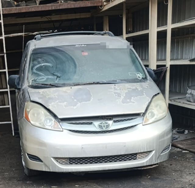Silver Toyota Sienna minivan for parts, front view with hood, bumper, grille and headlights, Sharjah market