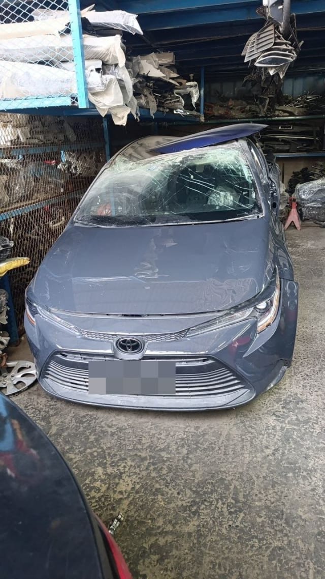 Grey Toyota Corolla sedan for parts with front bumper, grille and headlights, damaged roof, Sharjah market