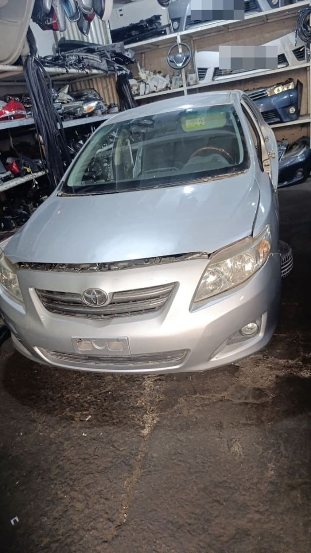 Silver Toyota Corolla sedan halfcut: front bumper, grille, headlights and hood, Sharjah market