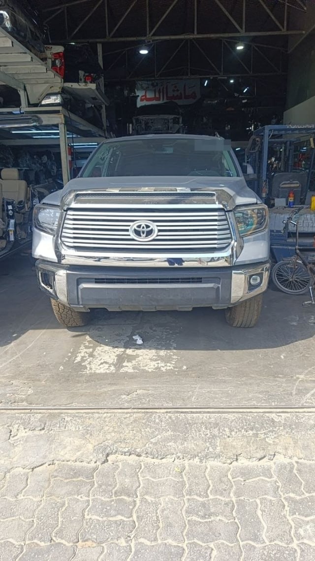 Silver Toyota Tundra pickup for parts, front view: chrome grille, headlights, hood and bumper, Sharjah market