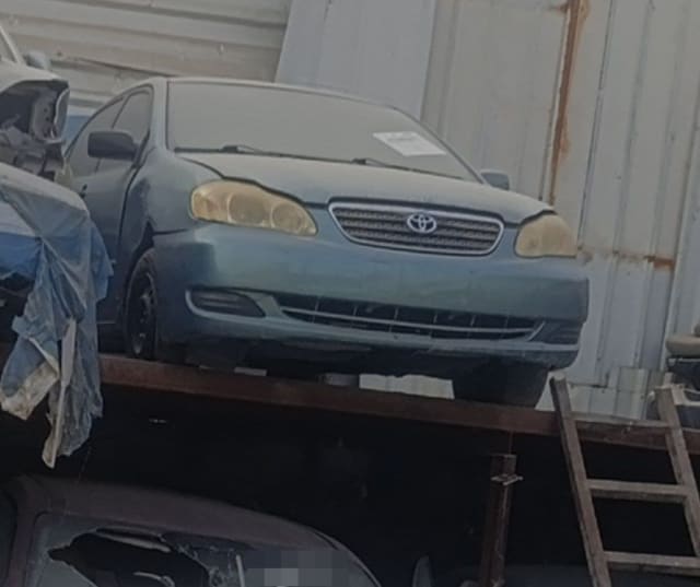 Blue-grey Toyota Corolla sedan halfcut front — bumper, grille, headlights and hood, Sharjah market