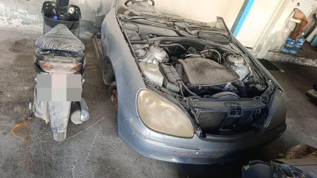 Silver-blue Mercedes-Benz S-Class front halfcut — open engine bay, headlights, bumper, radiator, Sharjah market