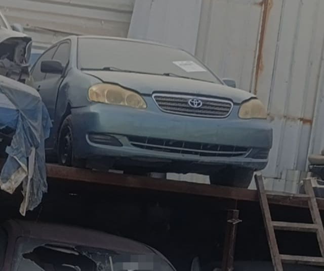 Blue-grey Toyota Corolla sedan halfcut — front bumper, grille, headlights and hood, Sharjah market