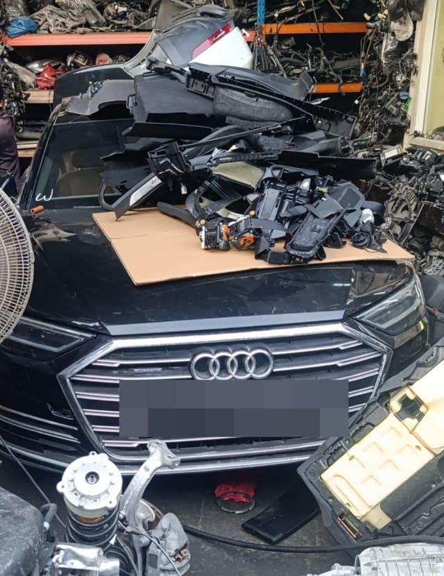 Black Audi A8 halfcut front: grille, headlights, hood with stacked interior trim, Sharjah market