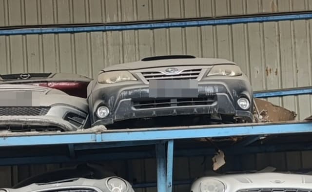 Silver Subaru Impreza XV front halfcut on rack, hood, grille, headlights and fog lights, Sharjah market